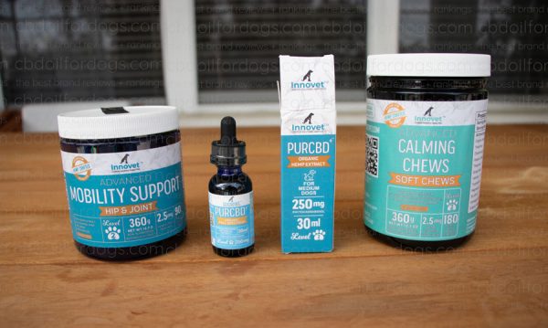 PurCBD products for Dogs from Innovet displayed on a wooden table.